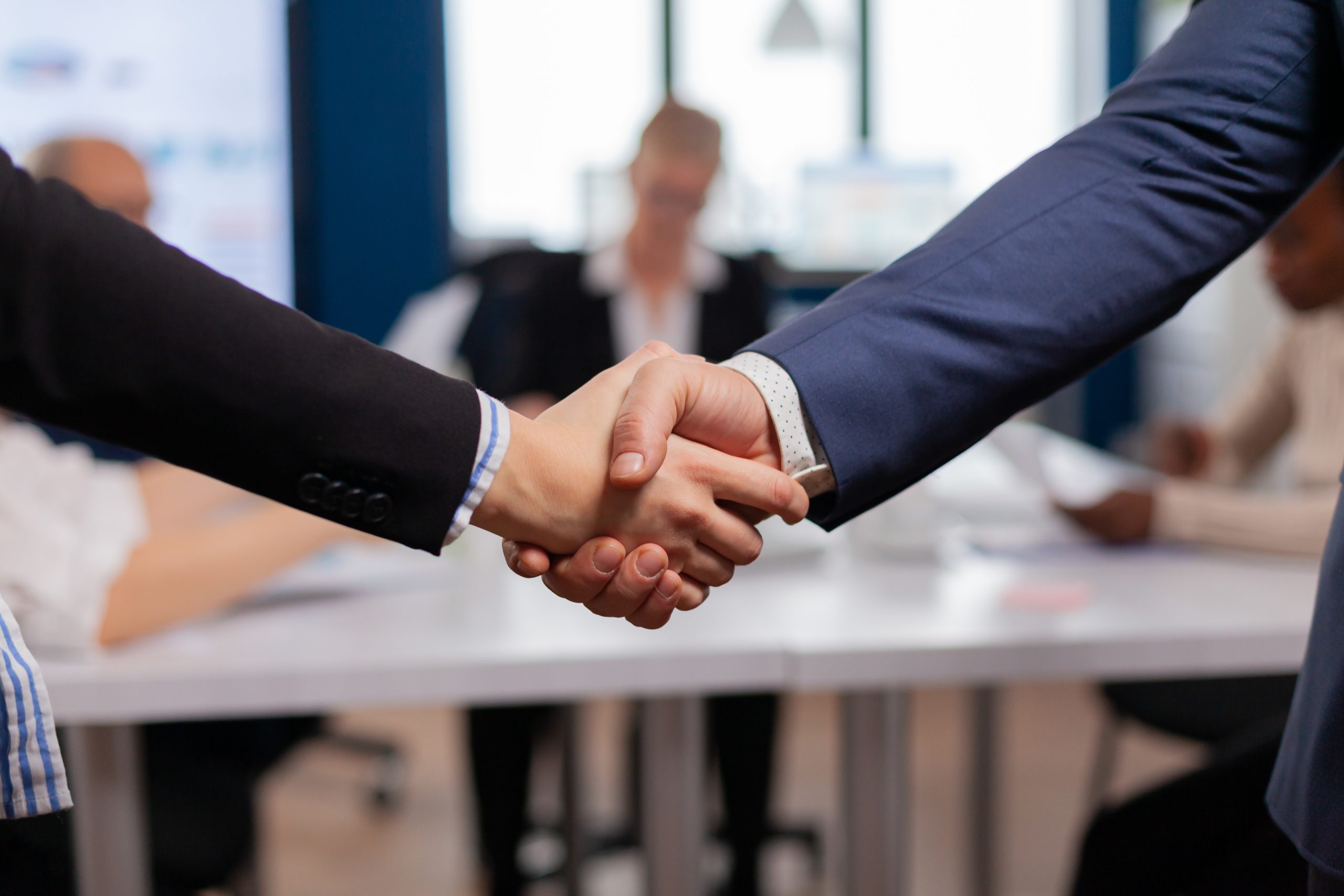 Seja Parceiro TWO 13 professional handshake in an office meeting 2026 01 07 06 40 58 utc scaled Seja Parceiro TWO